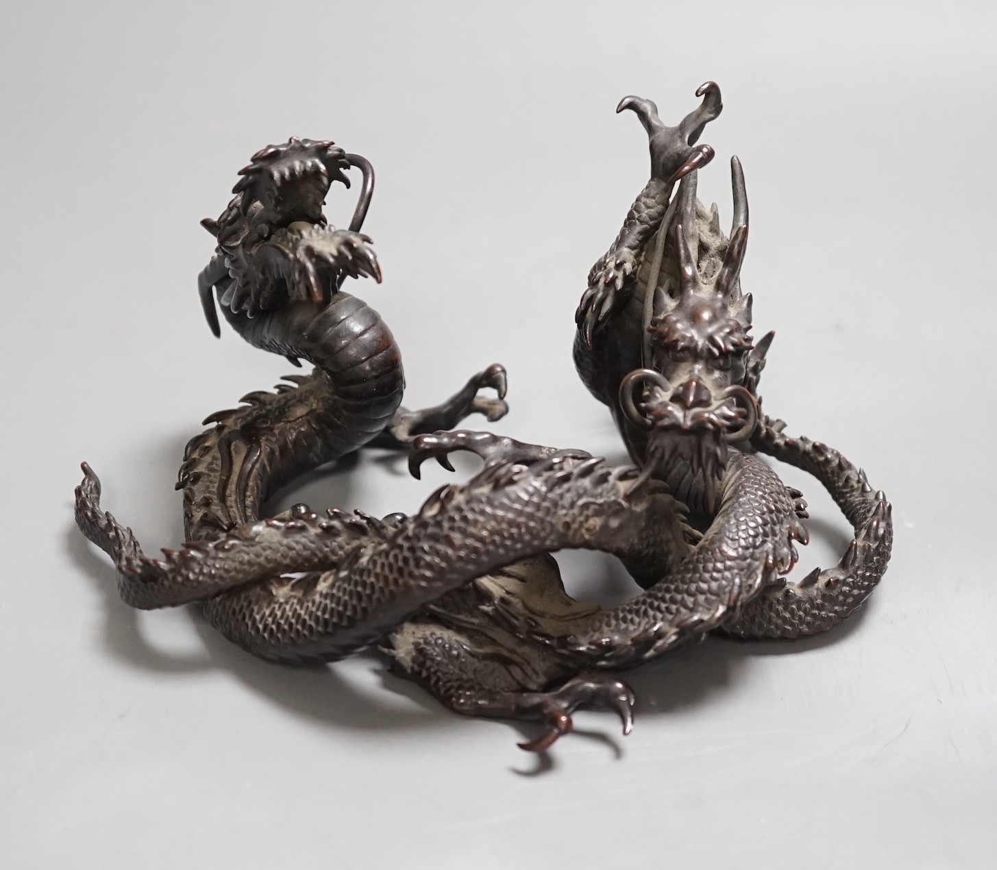 A Japanese bronze group of two entwined dragons, Meiji period, 17cms wide